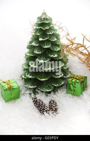 Christmas candle in the snow with gift packages Stock Photo