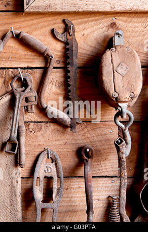 Assorted old work tools on wooden wall Stock Photo