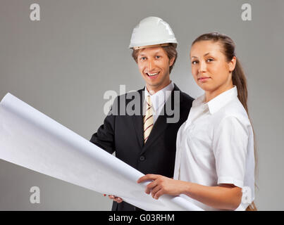 An architect wearing a hard hat and co-worker Stock Photo