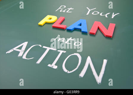 Put your plan into action, words on blackboard. Stock Photo