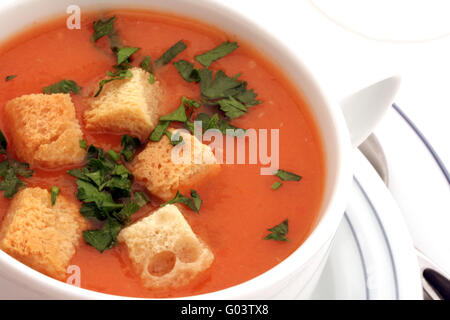 Tomato soup with croutons in ceramic bowl on white Stock Photo