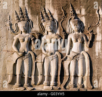 Three dancing apsara on the wall in Angkor Wat Stock Photo