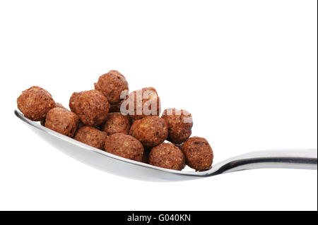 Chocolate cornflakes. A dry breakfast in a spoon. Stock Photo