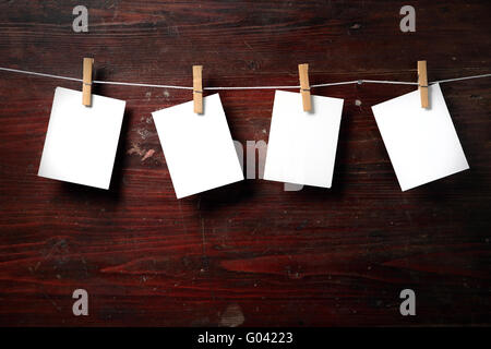 Photo paper attach to rope with clothes pins Stock Photo