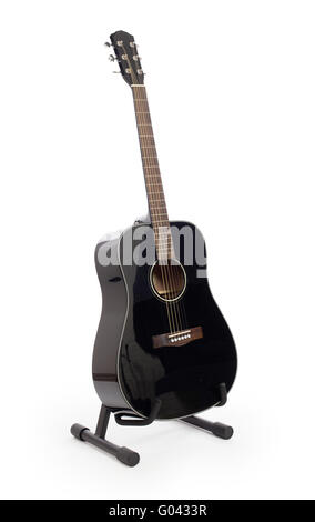 Black acoustic guitar on stand, isolated on a white background Stock Photo