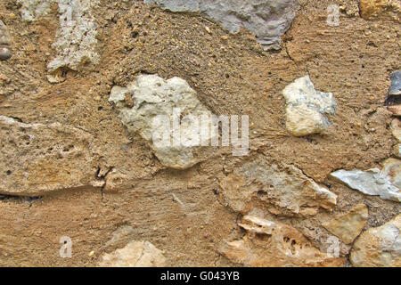 Old grey and brown stone wall in town Stock Photo