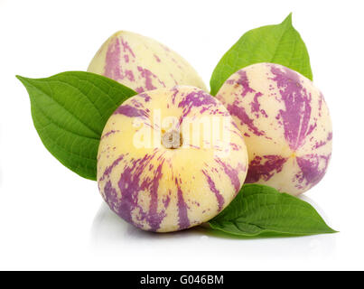 Ripe tropical Pepino fruit with green leaves isolated Stock Photo