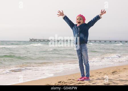 Seven-year girl rejoices arrival of the sea Stock Photo