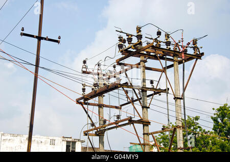 rusted electricity poles with many wires in urban area, India Stock Photo