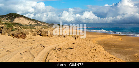 Storm clouds hover over the Indian Ocean at Buffalo Beach near Bunbury Western Australia on a calm late winter afternoon in this beautiful scene. Stock Photo