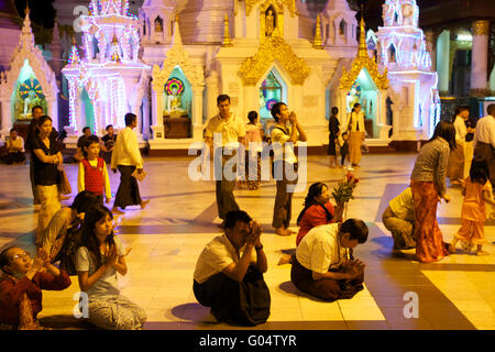 Praying at the Shwedagon Pagoda, Myanmar Stock Photo