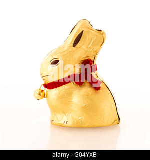 Chocolate gold foil wrapped rabbit against white background. Stock Photo