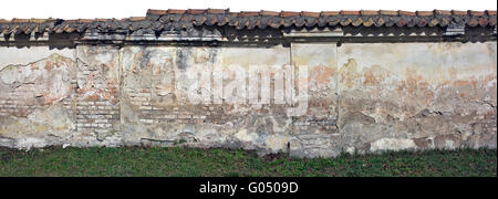 The destroyed clumsy ugly brick fence fragment - ruins of the beginning of the 20th century. Isolated collage from several photo Stock Photo