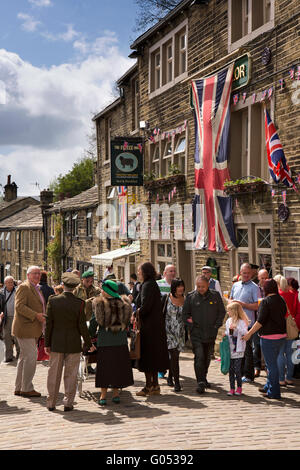 UK, England, Yorkshire, Haworth 40s Weekend, Main Street, visitors in costume outside Fleece Inn Stock Photo