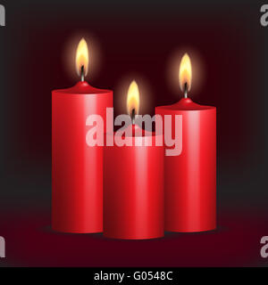 Three red wax candles burning in darkness on dark background Stock ...
