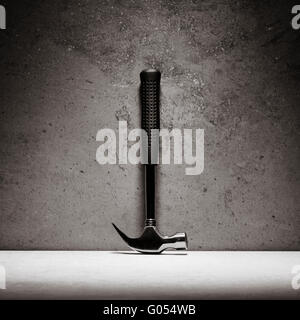 Hammer and stone wall. Still life of work tool. Concept of diy and repair. Stock Photo