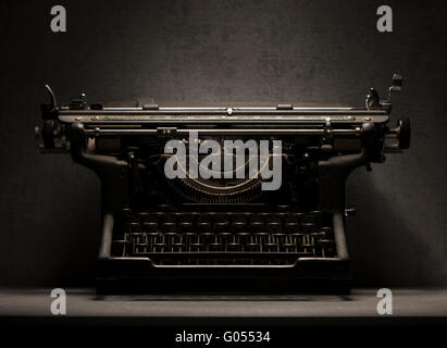Old typewriter still life. Vintage model on stone table. Concept of writing, old fashioned correspondence and journalism. Stock Photo