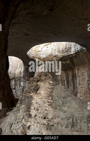 Hole deep in the ceiling. Inside cave with through hole on cave ceiling ...
