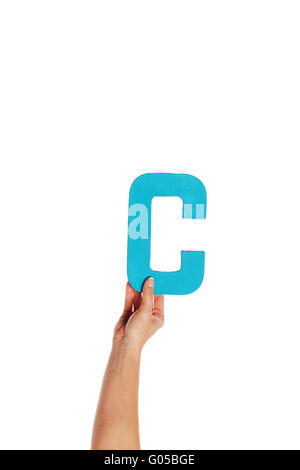 hand holding up the letter C from the bottom Stock Photo