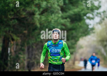 single young male runner in Park during Half marathon in woods Stock Photo