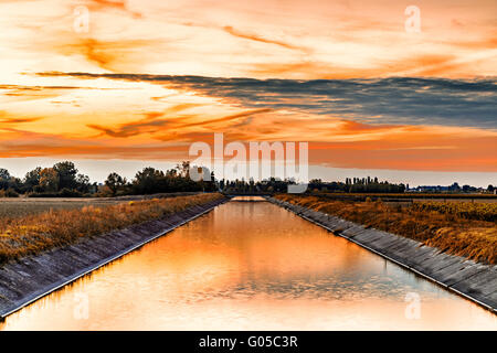Channel to divert river water for irrigation of cultivated fields Stock Photo