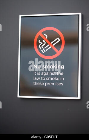 Black No Smoking sign on black wall Stock Photo