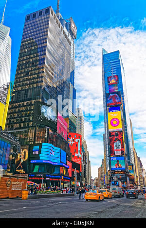 New York, USA - April 26, 2015: Skyscrapers and tourists in Times Square on Broadway and 7th Avenue in Midtown Manhattan in New Stock Photo