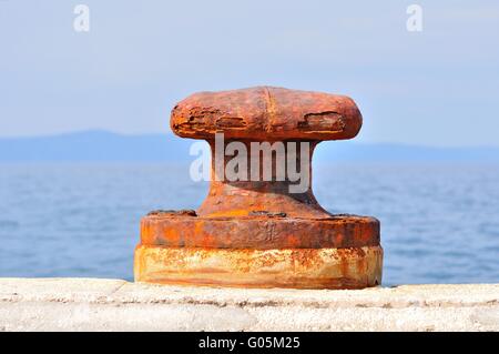 Old, rusty mooring bollard on port of Podgora, Croatia Stock Photo