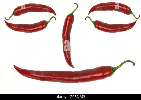 Smiley from red chili peppers on a white backgroun Stock Photo