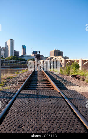 robert street multiple arch bridge and railroad tracks leading to vertical lift bridge spanning mississippi river in saint paul Stock Photo