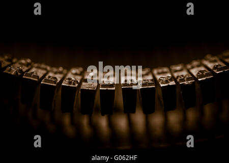 Letters on typewriter in extreme close up. Concept of writing, old fashioned correspondence and journalism. Stock Photo