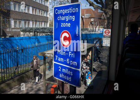 Aerial view of a bus stop and TFL Congestion Charging Zone sign, seen from the top deck of a London bus, outside King's College Hospital. Stock Photo