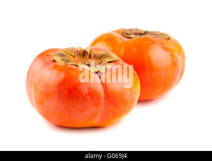 Two ripe persimmon fruits on white background Stock Photo