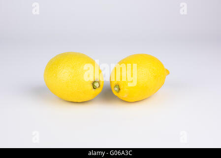 A pair of whole lemons on a white background Stock Photo