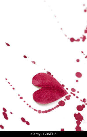 White background with a paper heart and red splashes Stock Photo