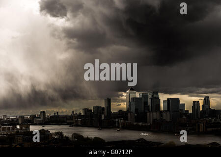 London, UK. 29th April, 2016. UK Weather: dramatic dark storm clouds over Canary Wharf business park buildings and River Thames in South East London Credit:  Guy Corbishley/Alamy Live News Stock Photo