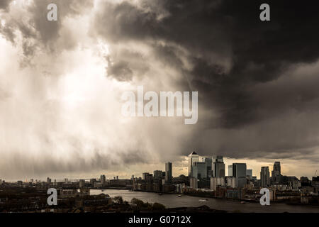 London, UK. 29th April, 2016. UK Weather: dramatic dark storm clouds over Canary Wharf business park buildings and River Thames in South East London Credit:  Guy Corbishley/Alamy Live News Stock Photo