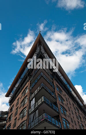 Tall building with angled roof against the blue sky Stock Photo