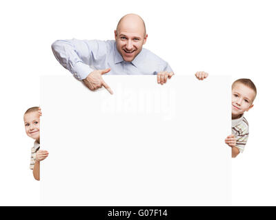 Father and sons holding blank sign or placard Stock Photo