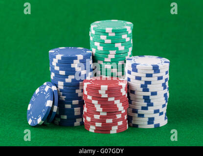 Poker chips on green playing table background Stock Photo