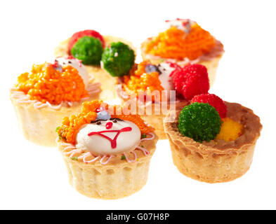 Cupcakes with smiley faces isolated on white. Stock Photo