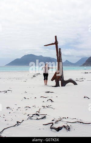 Woman standing at Shipwreck Kakapo at the beach of kommetjie Stock Photo
