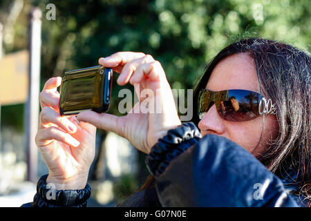 Dark Haired Woman Taking  A Photo With Cellphone Stock Photo
