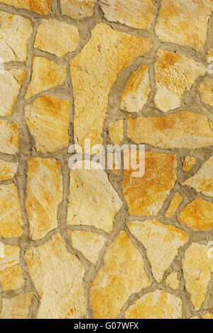 Background of a large stone wall texture (yellow) Stock Photo