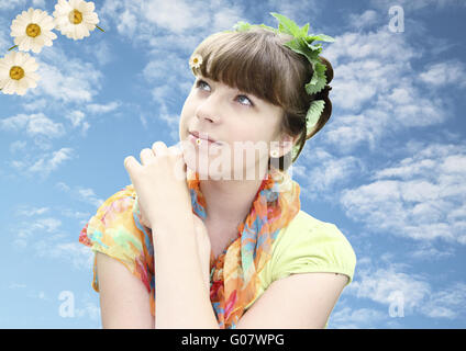 The young romantic  girl against the sky with leav Stock Photo