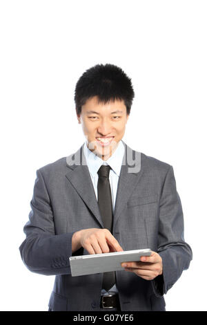 Smiling Asian young businessman using a PC tablet Stock Photo
