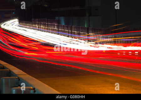 Abstract image of the light trails in night traffic in the city. Speeding concept Stock Photo