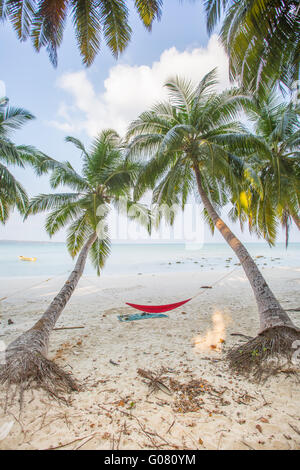 A hammock between two palm trees facing the Andaman sea on Havelock Island Stock Photo