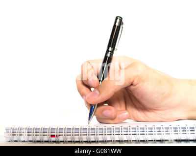 Hands with pen on notebook isolated on white background Stock Photo