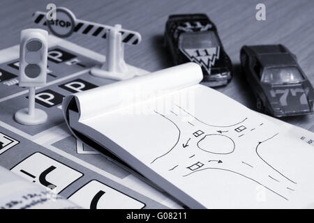 Notepad, book of traffic rules and pen on a desk table. Studying and preparing for driving test exam Stock Photo